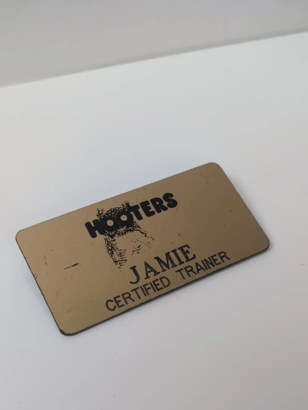Hooters Gold Name Badge with Black Logo and Text